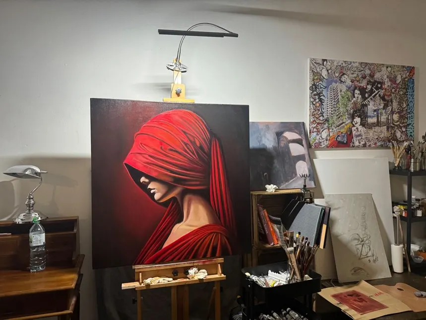The unfinished oil painting on its easel in the studio